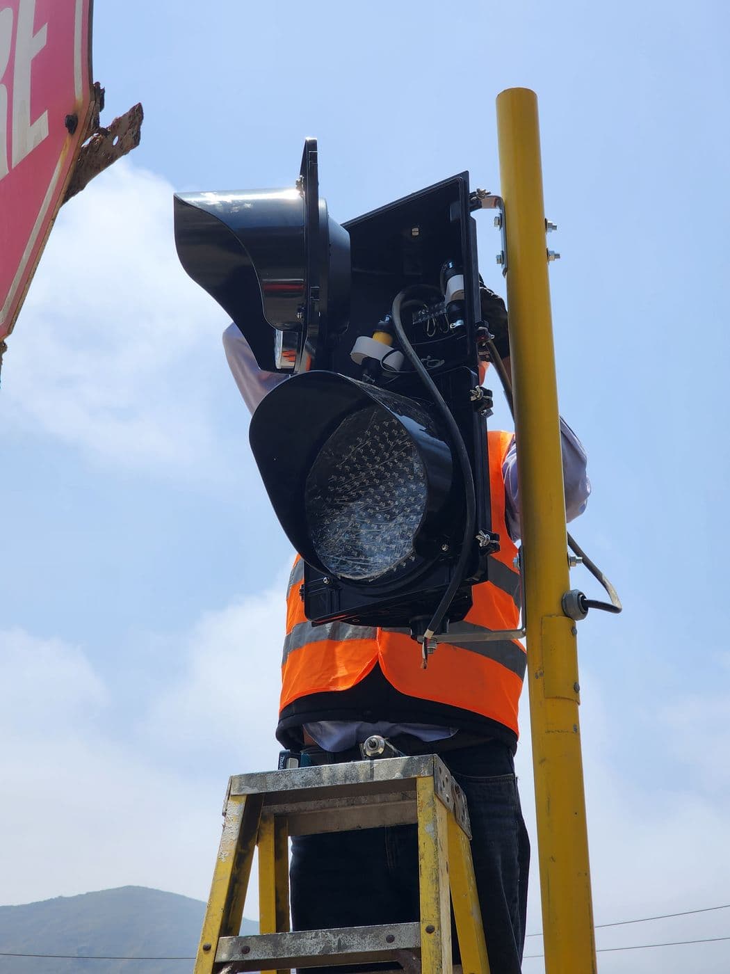 Detalle del cabezal LED de un semáforo industrial durante su montaje, con el cableado a la vista.
